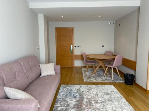 a living room with a couch and a table at Hotel Playa de Laxe in Laxe