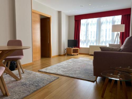 a living room with a couch and a table at Hotel Playa de Laxe in Laxe