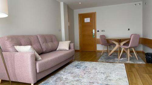 a living room with a couch and a table at Hotel Playa de Laxe in Laxe