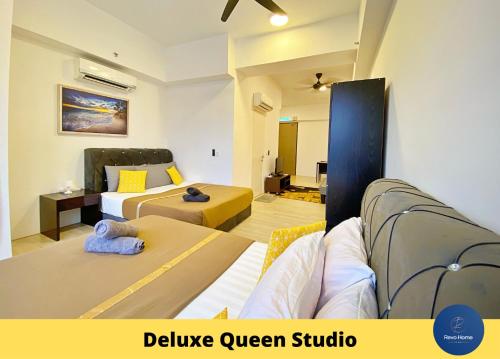 a bedroom with two beds and a living room at Revo Home at Pavilion Bukit Jalil in Kuala Lumpur