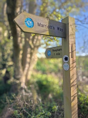 a wooden sign for a path in a park at Whitwell and Reepham Station - Tom in Norwich