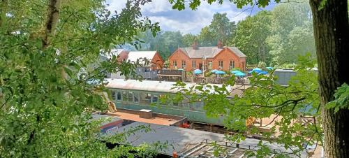 a train is parked in front of a house at Whitwell and Reepham Station - Tom in Norwich