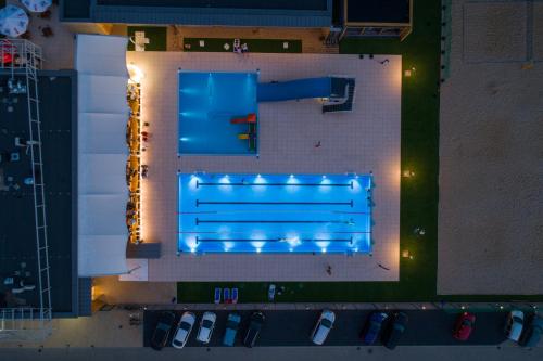 an overhead view of a swimming pool with blue lights at Hotel Kozerki in Kozerki