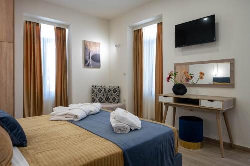 a hotel room with a bed with towels on it at Kalypso Apartments in Kalamata