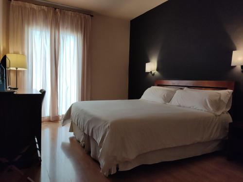Postel nebo postele na pokoji v ubytování Puerta De España