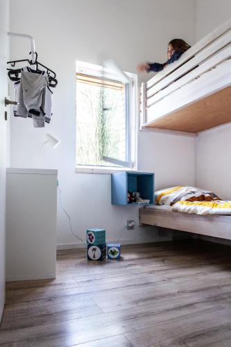 a bedroom with a bunk bed and a window at Gvendolína in Lejčkov