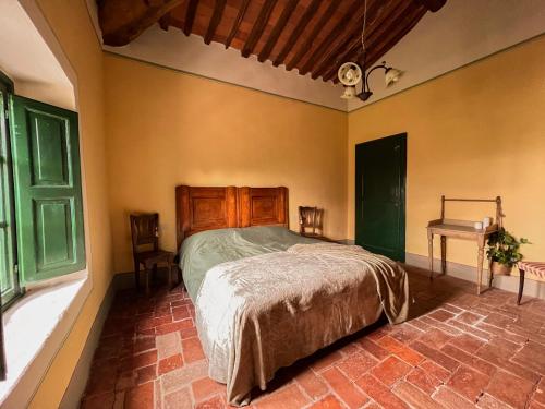 מיטה או מיטות בחדר ב-Borgo Al Canto Degli Alberi