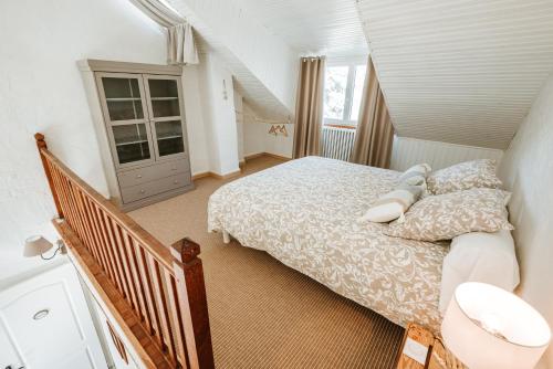 TralaiguesにあるRelais des combraillesの小さなベッドルーム(ベッド1台、階段付)