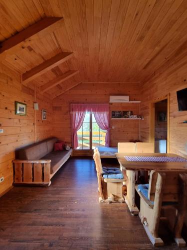 a room with a couch and a table in a cabin at Apartments Zafran in Smoljanac