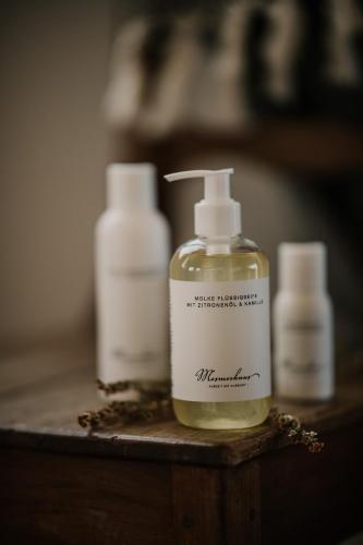 three bottles of moisturizers are sitting on a table at Mesmerhaus in Bildstein