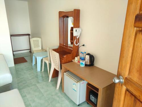 a room with a desk and a phone on the wall at Dalum Beachhouse in Phi Phi Don