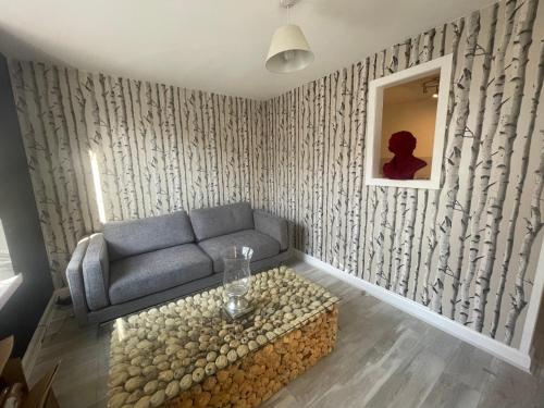 a living room with a couch and a table at Alpine Apartments - 2 in Blairgowrie