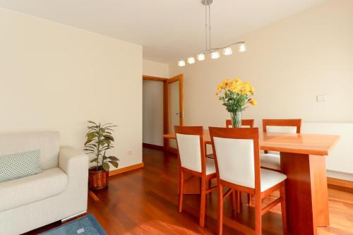 a dining room and living room with a table and chairs at Sweet Living Viana - City Centre Apartment with Garage in Viana do Castelo