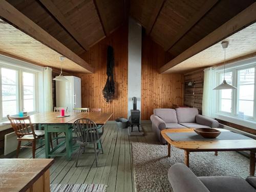 a living room with a couch and a table at Sakrisøy Rorbuer in Reine
