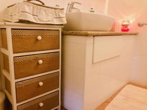 a bathroom with a sink and a counter with drawers at Cà Milla Argegno apartment in Argegno