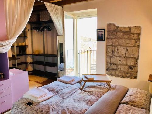 a bedroom with a bed with a table on it at Cà Milla Argegno apartment in Argegno