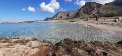 a beach with a bunch of rocks in the water at B&B La mia Isola in Castelluzzo