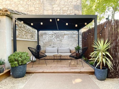 a gazebo with a couch on a patio at La Blanchisserie in Maussane-les-Alpilles