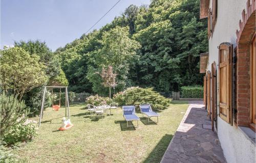 a patio with chairs and a swing in a yard at Casa Ciricea in Piteccio