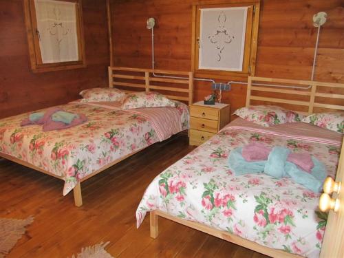 two beds in a room with wooden floors at Robinson House Istra Vižinada Poreč in Vižinada