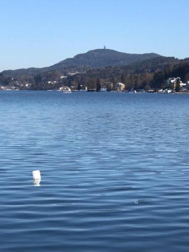 a white buoy in the middle of a large lake at Ferienwohnung Kusternik in Velden am Wörthersee