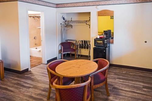 a kitchen and dining room with a table and chairs at Rodeway Inn Albuquerque Downtown on Rt 66 in Albuquerque