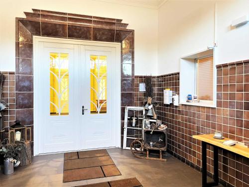 a bathroom with a white door with stained glass windows at IBS Begegnungszentrum in Laubusch