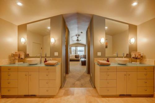 a bathroom with two sinks and two mirrors at Mackinaw Manor by Casago McCall - Donerightmanagement in McCall