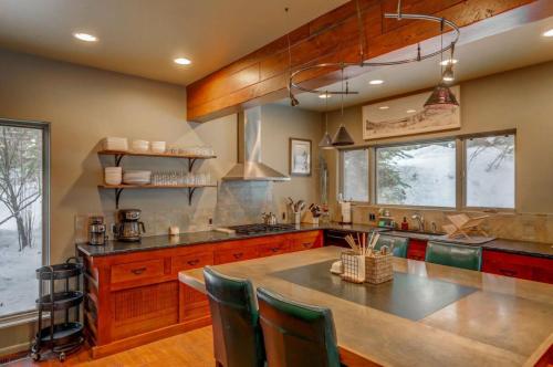 a kitchen with wooden cabinets and a large kitchen island at Mackinaw Manor by Casago McCall - Donerightmanagement in McCall
