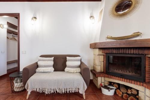 a living room with a chair and a fireplace at Facundo A in Barlovento