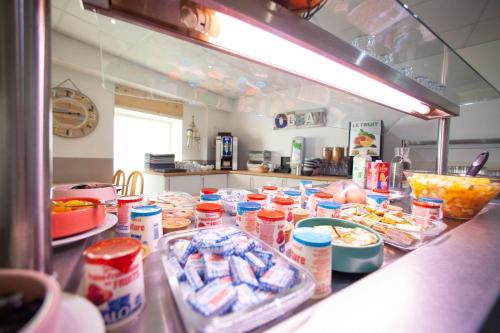a kitchen with a counter with lots of food at La Marine in Carnac