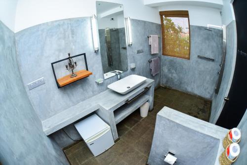 a bathroom with a sink and a shower at TROPICAL HOUSE - Jungleside Villa in Hikkaduwa