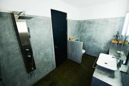 a bathroom with a sink and a shower and a toilet at TROPICAL HOUSE - Jungleside Villa in Hikkaduwa