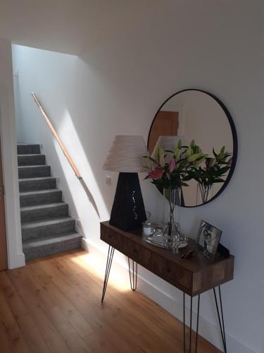 a room with a table with a mirror and stairs at An Sean Teach in Fodry