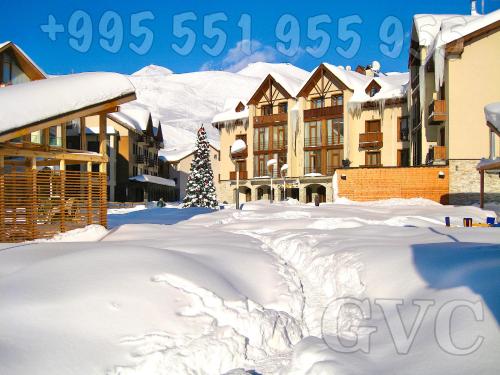a pile of snow in front of some buildings at GVC 240 New Gudauri in Gudauri