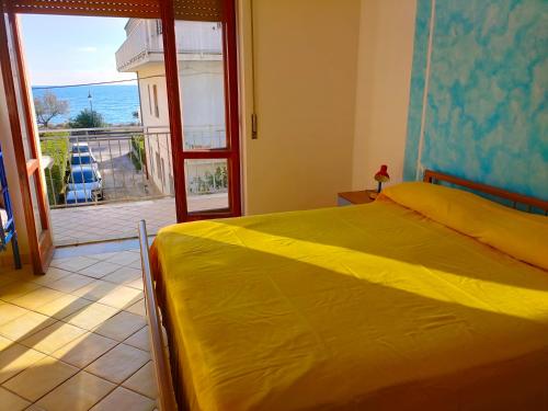 a bedroom with a bed and a view of the ocean at A Levante in Ascea