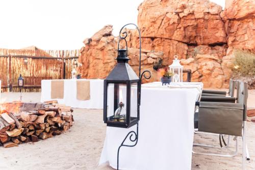 a black lantern sitting on a table at a wedding at Kagga Kamma Nature Reserve in Lochlynne