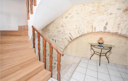 a staircase in a house with a table on the wall at Holiday Home Cessenon Sur Orb Mn-1265 in Cessenon