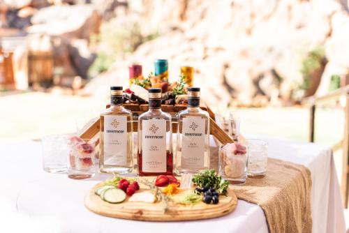 a table with bottles of wine and fruit on it at Kagga Kamma Nature Reserve in Lochlynne