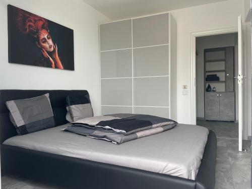 a bedroom with a large bed with white walls at Lakeview 2 Room Penthouse Rooftop Terrace W15 in Bucharest