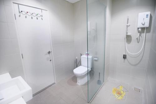 a white bathroom with a shower and a toilet at I-City Homestay@5 min walk to shopping Mall in Shah Alam