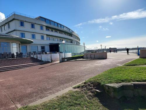 a building on the beach with people walking in front of it at 2 bed apartment 5min from sea in bare Morecombe in Morecambe