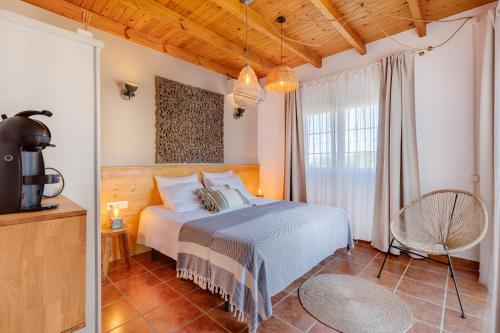 a bedroom with a bed and a large window at Bed And Breakfast Mirador Infinito in Alhaurín el Grande