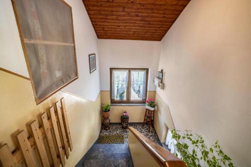 a hallway with a bench and a window at La Mansarda di Chiara e Silvio in Trasquera
