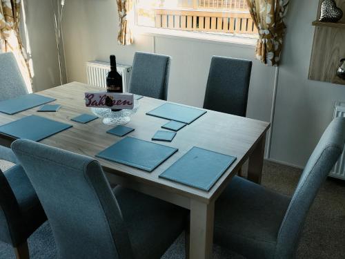 a dining room table with a bottle of wine on it at Remarkable 3-Bed House in Hull in Hull