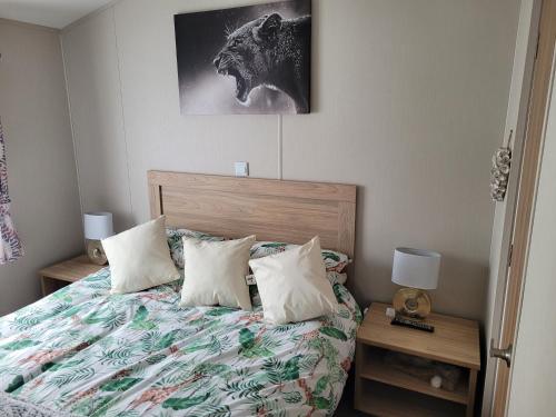 a bedroom with a bed with pillows and a picture at Remarkable 3-Bed House in Hull in Hull