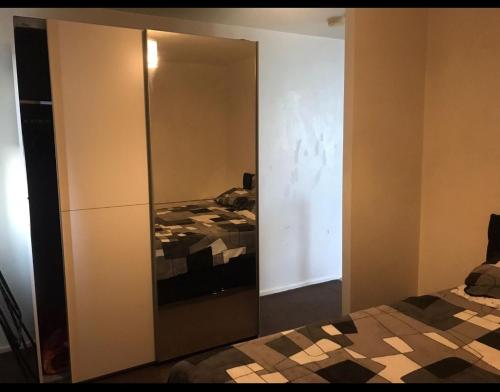 a bedroom with a mirrored closet with a bed at Immaculate 1-Bed Apartment in Stoke-on-Trent in Stoke on Trent