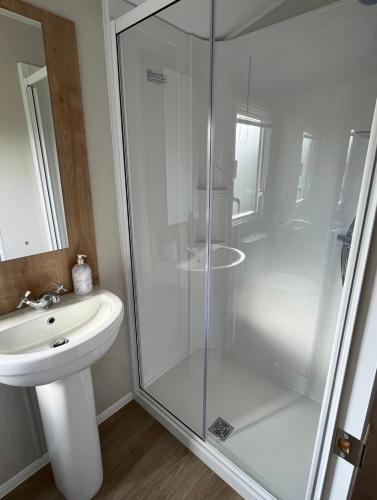 a bathroom with a shower and a sink at 2 Bed - Sleeps 6 - 15min Walk to Beach in Morecambe