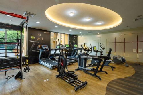 a gym with a bunch of treadms and ellipticals at Camino Real Polanco Mexico in Mexico City