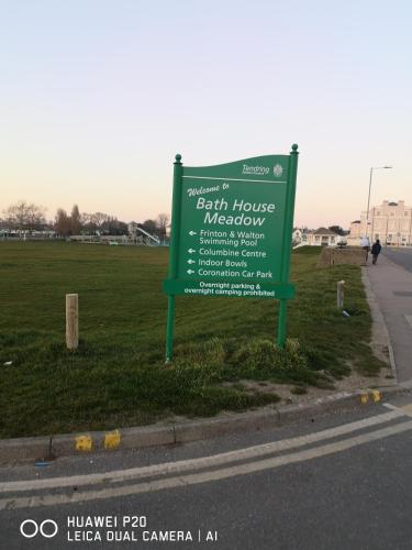 a green sign on the side of a road at Lovely 2-Bed caravan in Walton on the Naze in Walton-on-the-Naze